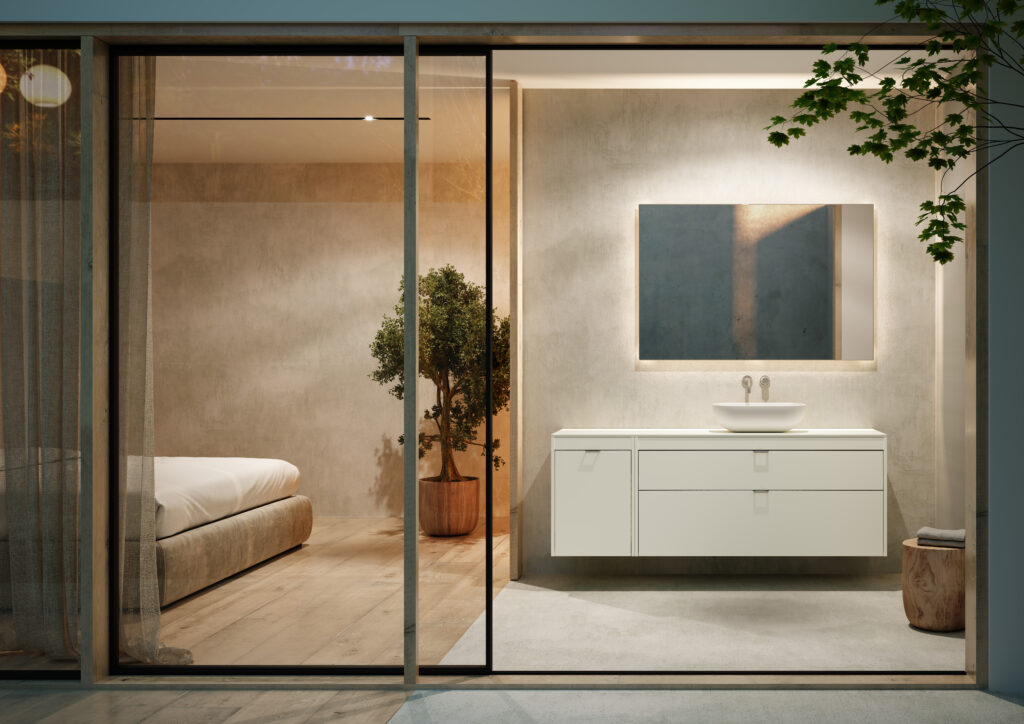 Modern bathroom with a minimalist design featuring a white vanity and sink. A large mirror reflects soft lighting. A nearby room shows a cozy bed and potted plant.