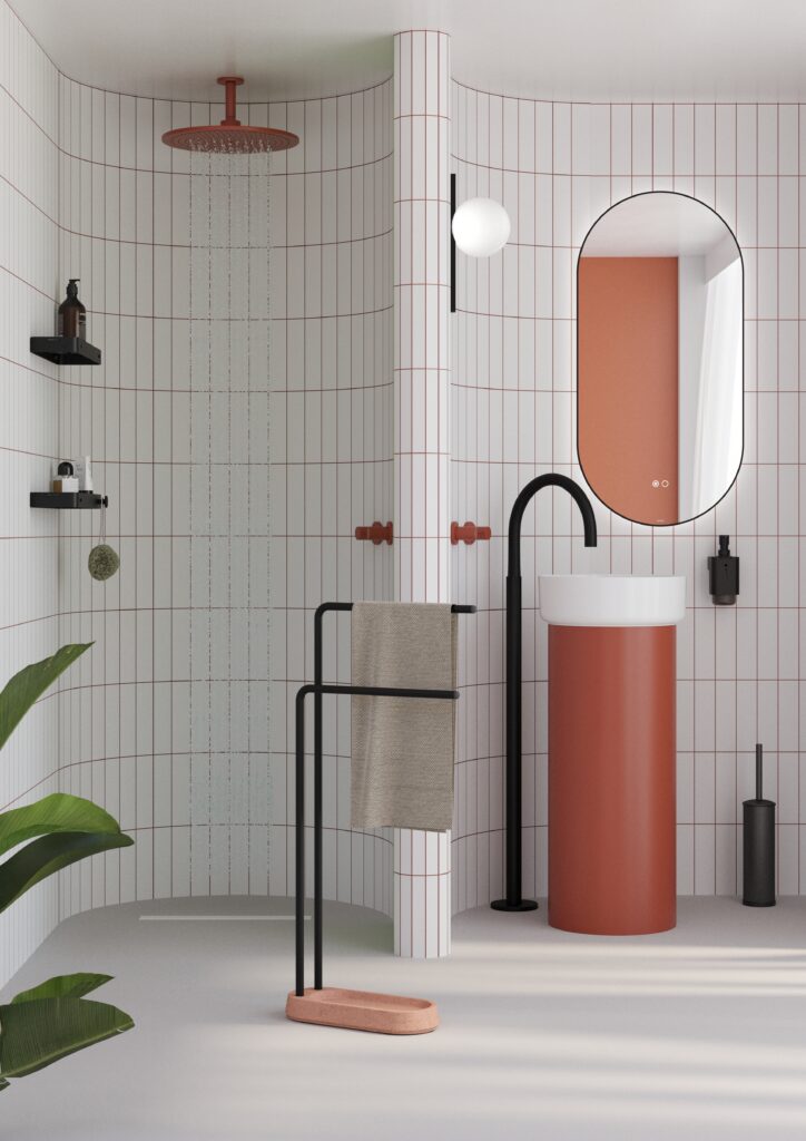 Minimalist bathroom with white tiles, red grout, and red fixtures. Features different accessories such as a tall, red pedestal sink, oval mirror, black faucet, and potted plant.