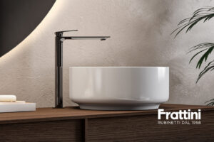 Contemporary bathroom setup showcasing the Frattini Narciso vanity console with a double sink, minimalist brass frame, and matching round mirrors.