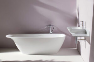 Minimalist bathroom corner featuring the Laufen Ino SaphirKeramik washbasin with an integrated shelf, mounted on a dark wooden vanity console.