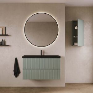 Contemporary bathroom furniture display showcasing a two-drawer Royo Vora unit in sage green with a black basin and a large circular mirror.