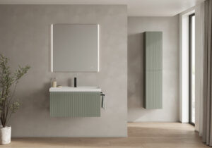 Compact wall-mounted bathroom furniture from the Royo Vora collection in a fluted matte green finish, complete with a tall storage column.
