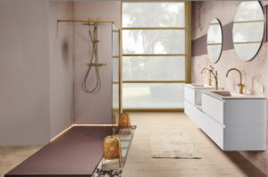Modern bathroom with sleek glass shower and golden fixtures on the left. Dual white sinks and round mirrors on the right, soft light through large window.