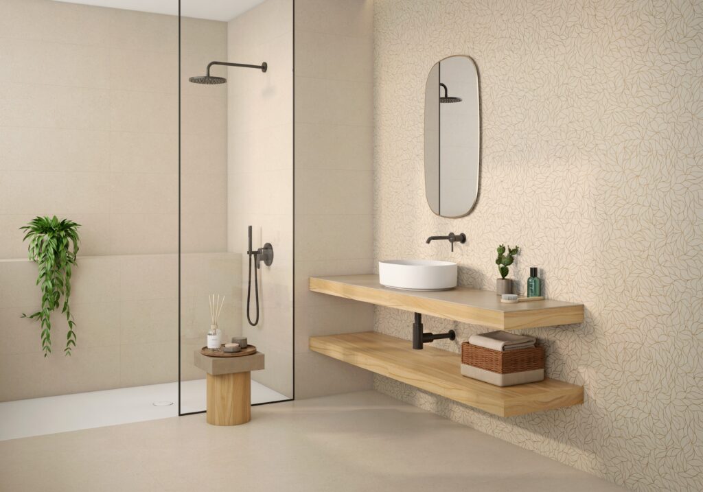 Modern bathroom with minimalist design, featuring a walk-in shower with glass walls and a black showerhead. A wooden floating vanity holds a vessel sink, with a round mirror and decor items adding elegance.