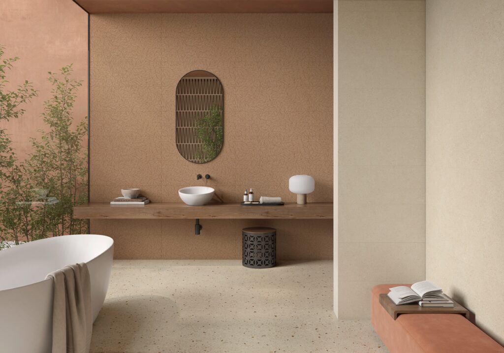 Modern bathroom with a freestanding white bathtub and towel, minimalist wooden vanity with round basin, potted plants, and a warm, earthy color palette.