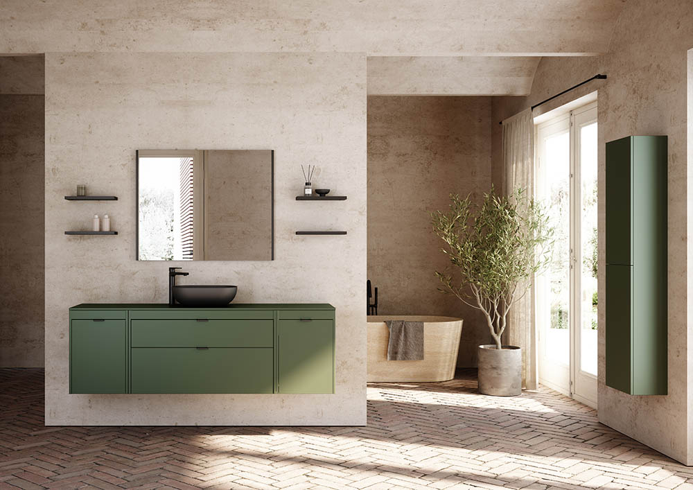 Modern bathroom with green cabinetry and matte black fixtures. A large mirror, shelves with decor, and a potted plant add elegance. Natural light fills the space.