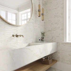 Luxury bathroom vanity with a white marble sink, featuring wavy textured marble-look wall tiles from the Portobello Apuano Oro Stream collection.