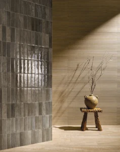 Modern interior wall showing a contrast between glossy vertical ceramic tiles and a fluted wood-look porcelain accent wall from Portobello.
